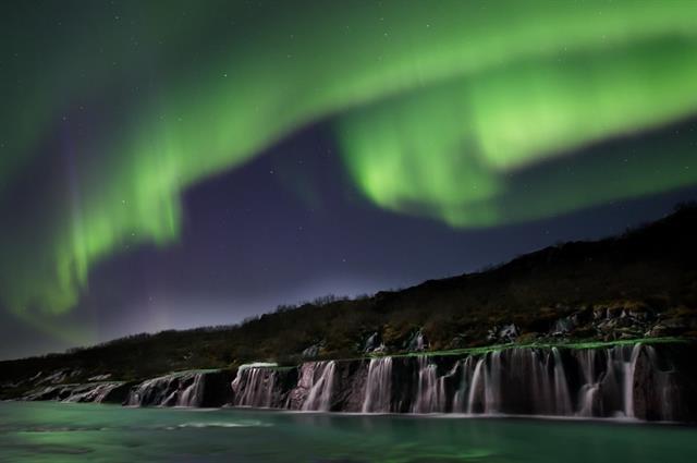 Aurora borealis over Hraunfossar waterfalls