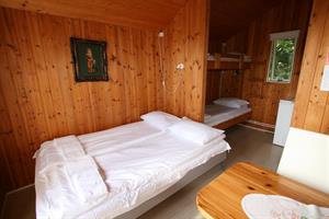 Double room with private bathroom and an additional bunk bed in a unit cottage