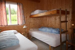 Two single beds and an upper bunk in each bedroom