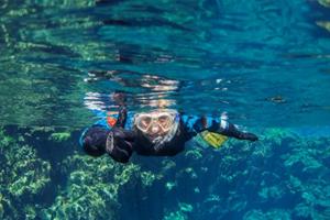 Snorkeling in the crystal clear water in Silfra